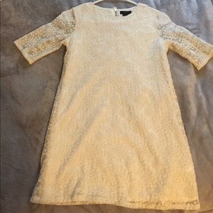 A creamy white mid sleeve lace dress